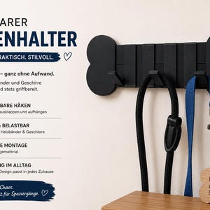 Könnte beinhalten: Ein schwarzer, knochenförmiger Wand-Leinenhalter mit drei klappbaren Haken. Der Text lautet KLAPPBARER LEINENHALTER, SCHLICHT. PRAKTISCH. STILVOLL., Ordnung im Flur – ganz ohne Aufwand., Hält Leinen, Halsbänder und Geschirre ordentlich bereit und stets griffbereit., 3 KLAPPBARE HÄKEN, STABIL & BELASTBAR, EINFACHE MONTAGE, ORDNUNG IM ALLTAG, Weniger Chaos. Mehr Zeit für Spaziergänge.