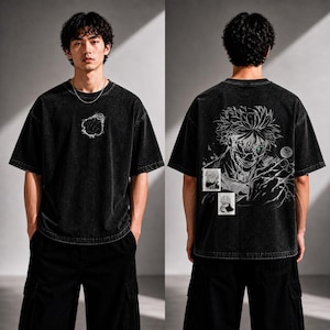 May include: Black oversized t-shirt with a distressed wash. The front features a white graphic. The back displays a detailed anime-style illustration with green eyes and two small images. The model is wearing black cargo pants.