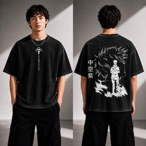 May include: Black t-shirt with a graphic design on the front and back. The front features a white symbol and Japanese text. The back displays a white illustration of a character and Japanese text. The shirt has short sleeves and a relaxed fit.