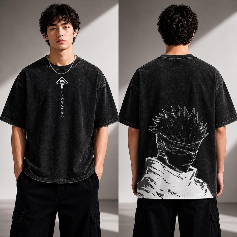 May include: Black, oversized t-shirt with a faded wash effect. The front features a white graphic and Japanese text. The back displays a large black and white illustration of a character with spiky hair and a blindfold.