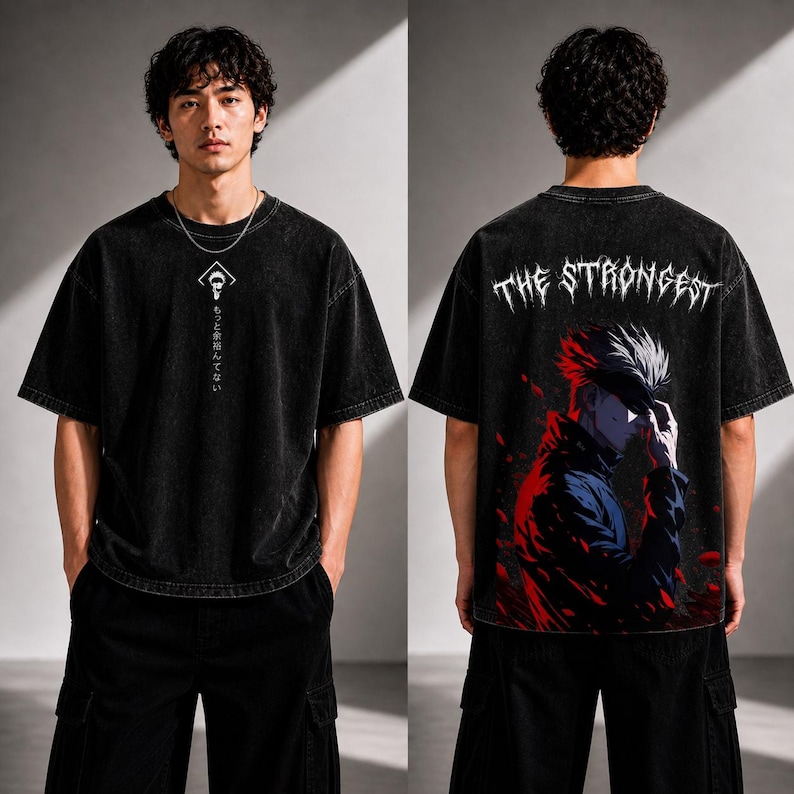 May include: Black oversized t-shirt with a graphic on the front and back. The front features a white symbol and Japanese text. The back displays an anime character with the text "THE STRONGEST" in white.