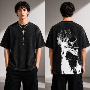 May include: Black oversized t-shirt with a white graphic on the front and back. The front graphic includes a symbol and Japanese text. The back features a large white illustration of a character. The shirt is paired with black cargo pants.