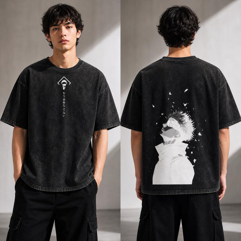 May include: Black, oversized t-shirt with a faded wash effect. The front features a white graphic and Japanese text. The back displays a large black and white anime-style illustration of a character looking upwards.
