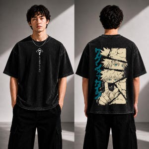 May include: Black oversized t-shirt with a graphic on the front and back. The front features a white design and Japanese text. The back displays a graphic of anime characters with Japanese text in teal.