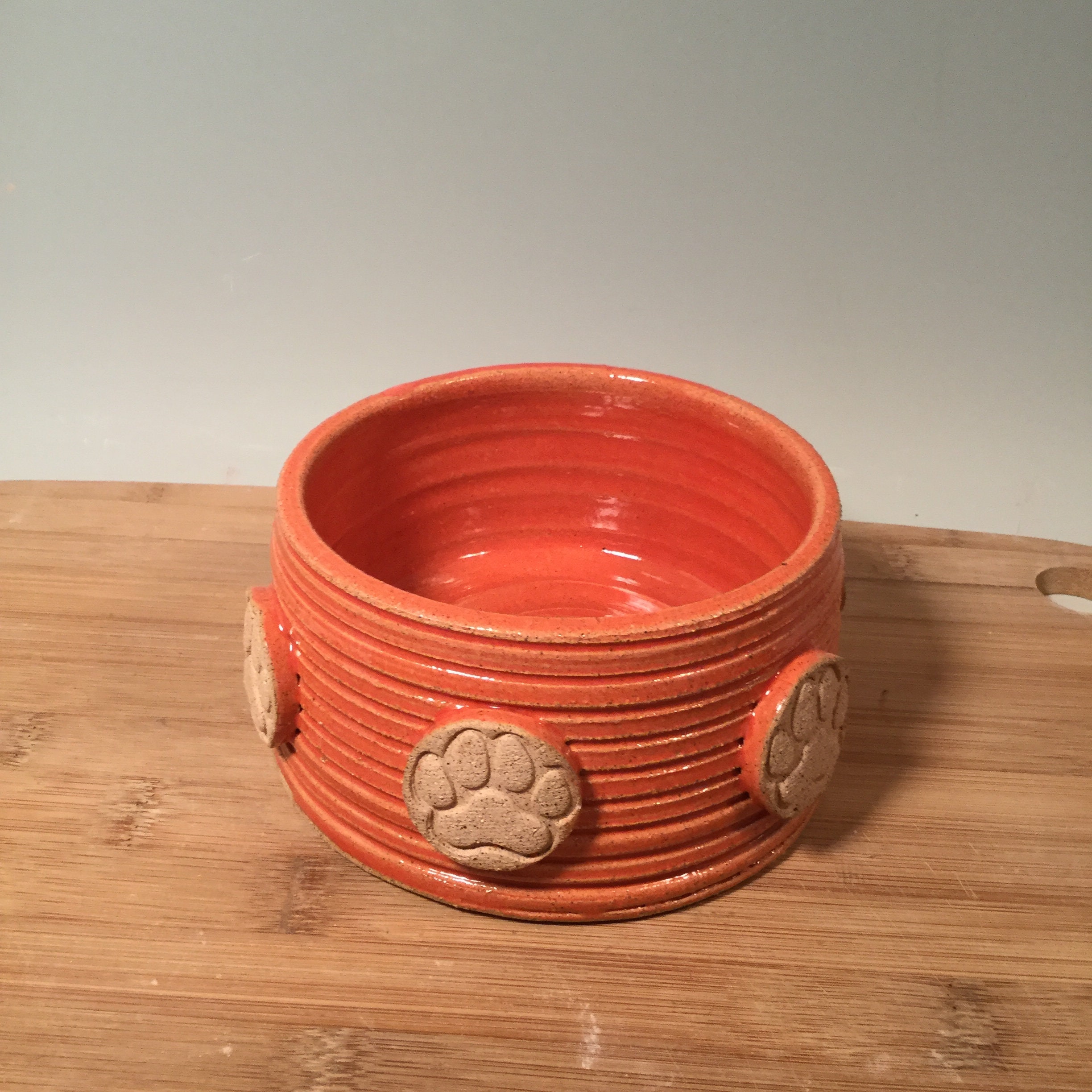 Small Pottery Pet Bowl: Coral Orange Stoneware Dish with Paw Prints
