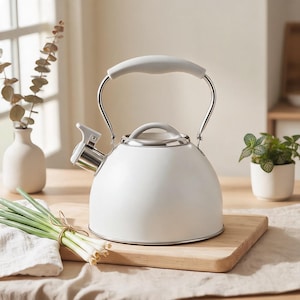 May include: A matte white stovetop kettle with a rounded body, a silver-toned spout, and a matching white handle. The kettle features a metallic rim at the base and a removable lid with a small handle, designed for heating water on a kitchen stove.