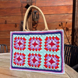 May include: A white ceramic mug with a black handle and the text "But First, Coffee" in a black, bold font. The mug is on a white surface.