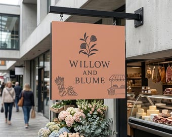 Puede incluir: Un letrero cuadrado colgante de color melocotón con el texto negro WILLOW AND BLUME. El letrero presenta ilustraciones de líneas negras de una rama de flor, un manojo de espárragos, un racimo de uvas y un pequeño puesto de mercado.
