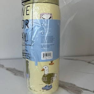 May include: A yellow and blue water bottle with a duck graphic wearing a jersey and sneakers. The bottle is wrapped in plastic and has the words "ER VE OR AY" visible. The bottle is designed for everyday use.