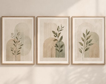 May include: A set of three framed wall art prints featuring vertical botanical illustrations of green leaves layered over beige and sage green arched shapes with fine line details. Each rectangular print is encased in a light wood frame.