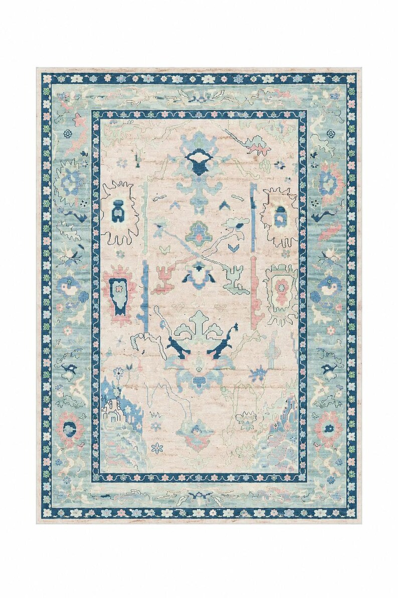 May include: Rectangular area rug with a light beige center and a border in shades of blue and teal. The rug features a detailed, ornate pattern with floral and geometric elements in blue, pink, and teal.