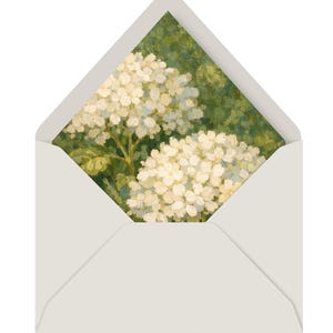 May include: A white envelope with a floral design on the inside. The artwork features a close-up of white hydrangea flowers against a green background. The envelope is open, revealing the artwork.