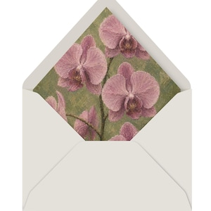 Puede incluir: Un sobre gris claro con la solapa abierta que revela un forro interior con un estampado al estilo de pintura al &oacute;leo de flores de orqu&iacute;dea rosa sobre un fondo verde salvia texturizado. El patr&oacute;n floral muestra varias orqu&iacute;deas.