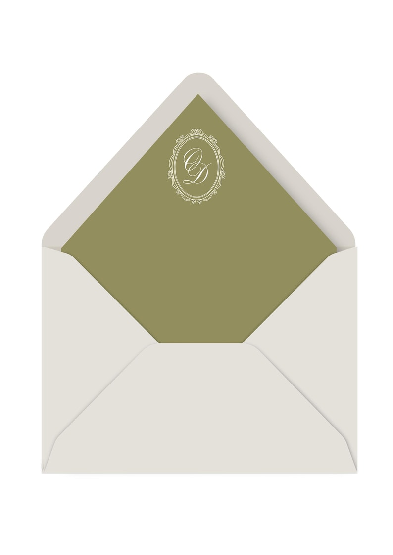 May include: An open white envelope with a sage green interior. The interior features a white, ornate monogram design. The envelope is a classic design, suitable for invitations or announcements.