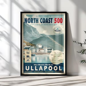 May include: A framed travel poster titled Scotland's North Coast 500 featuring a landscape illustration of mountains, a coastal village, and the town of Ullapool. The print includes a map of the route, icons for car, camper van, and motorcycle travel.