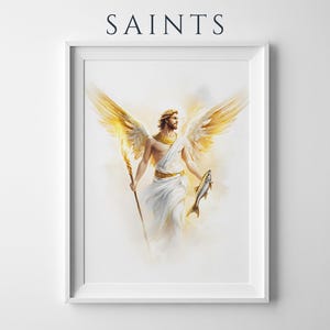 May include: A framed wall art print titled SAINTS featuring a watercolour-style illustration of a winged figure with golden wings, wearing white robes with gold accents, holding a staff in one hand and a fish in the other against a light background.