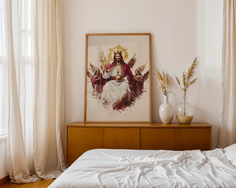 May include: A framed wall art print featuring a central figure with a golden crown and halo, wearing a white robe and red cloak, holding a golden orb. The figure is flanked by two winged angels on each side, rendered in a painterly style with warm tones.
