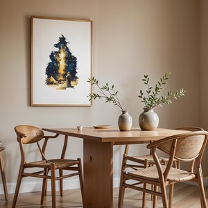 May include: A framed wall art print featuring a watercolour-style illustration of a figure standing in a desert landscape under a bright, glowing night sky filled with stars, displayed in a dining room with a wooden table and chairs.