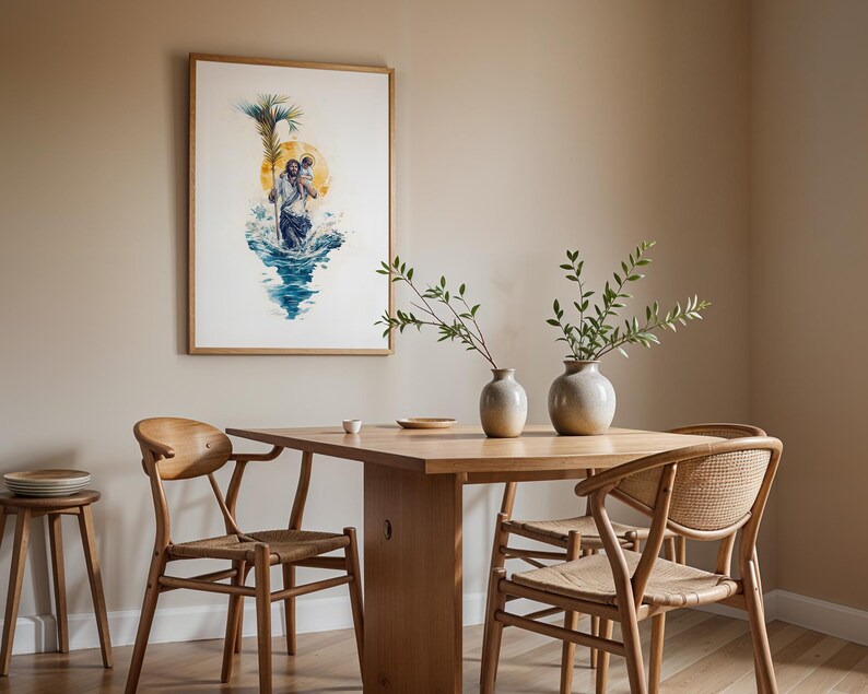 May include: A framed watercolor print depicting a figure carrying a child through blue water, set against a yellow sun and green palm frond. The artwork hangs above a wooden dining table with two ceramic vases and four wooden chairs.