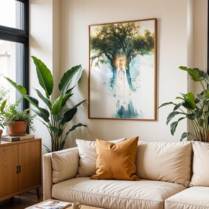 May include: A framed wall art print featuring a watercolour illustration of a figure in a white robe and crown standing before a large tree. The artwork uses shades of green, blue, and gold, displayed in a thin wooden frame on a white wall.