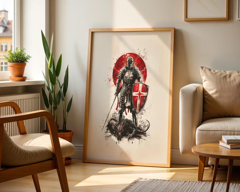 May include: A framed vertical wall art print featuring a knight in full armour standing over a defeated dragon. The knight holds a sword and a shield with a red cross emblem. The background includes a large red circle with ink splatter effects.