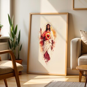 May include: A framed vertical wall art print featuring a watercolor-style illustration of a figure with long hair and a beard, wearing a white robe and red garment, with a glowing red heart on the chest and a golden halo around the head.