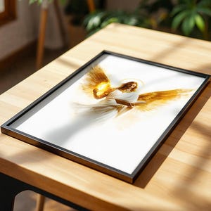 May include: A framed print featuring a central figure with large golden wings, a white robe, and a glowing halo. The figure holds a bright light in one hand and an open book in the other, set against a clean white background within a black frame.