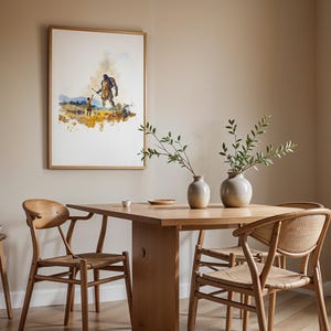 May include: A framed watercolor print depicting a large armored figure and a small child in a landscape, hanging above a light wood dining table with two round ceramic vases, three wooden chairs with woven seats, and a small wooden stool.