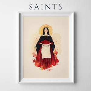 K&ouml;nnte beinhalten: Ein gerahmter Kunstdruck mit dem Titel SAINTS zeigt eine Aquarellillustration einer Figur mit langem dunklen Haar, einer goldenen Krone und einer Kreuzkette. Die Figur tr&auml;gt einen schwarzen Umhang &uuml;ber einem roten Kleid und h&auml;lt eine wei&szlig;e Sch&uuml;rze voller roter Rosen.