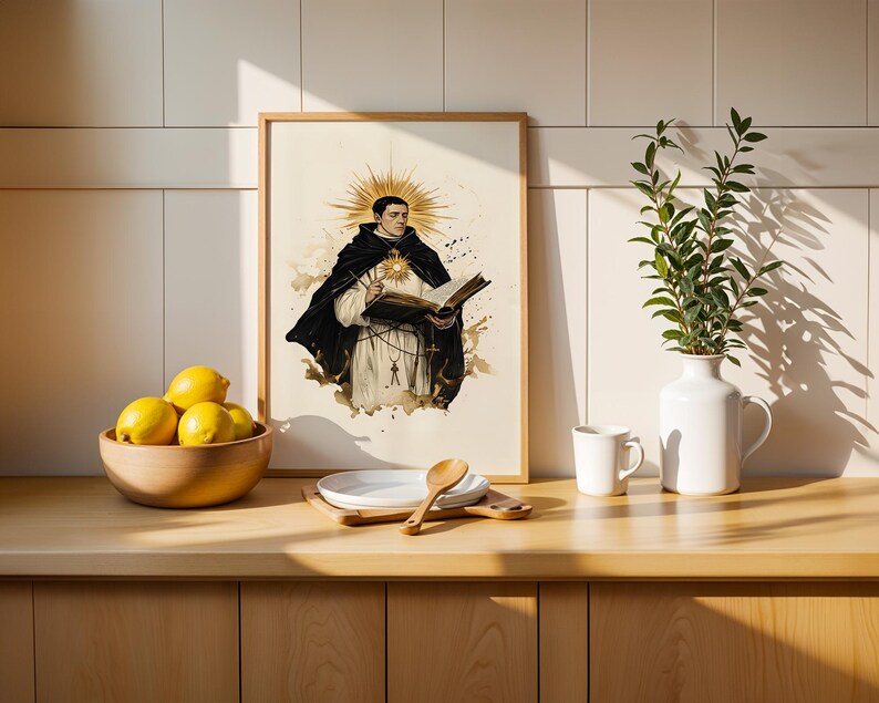 May include: A framed vertical art print featuring a religious figure in a black and white habit holding an open book, with a golden sunburst halo behind the head. The illustration is rendered in a watercolor style with sepia and ink tones.