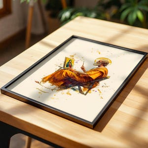 Puede incluir: Una l&aacute;mina enmarcada con una ilustraci&oacute;n estilo acuarela de una figura barbuda con t&uacute;nica naranja sentada en una silla, sosteniendo un pincel y pintando un peque&ntilde;o retrato de una mujer con t&uacute;nica azul y roja, con salpicaduras de pintura amarilla sobre fondo crema.