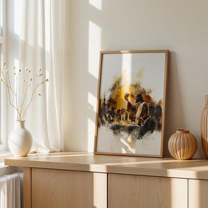 May include: A framed vertical wall art print featuring a watercolour-style illustration of the Last Supper. The artwork depicts a central figure holding a chalice at a table surrounded by others, rendered in warm golden, brown, and dark tones.