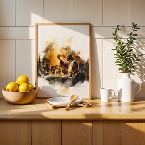 May include: A framed watercolour-style print depicting a group of people at a table with a central figure holding a round object, positioned next to a wooden bowl of yellow lemons, a stack of white plates with a wooden spoon, and a white vase with greenery.