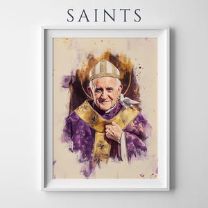 K&ouml;nnte beinhalten: Ein gerahmter Kunstdruck mit dem Titel SAINTS zeigt ein Aquarell-Portr&auml;t von Papst Franziskus in einer wei&szlig;en Mitra und violetten Gew&auml;ndern mit einer goldenen Stola. Eine wei&szlig;e Taube ruht auf der Schulter vor einem dunklen Heiligenschein.