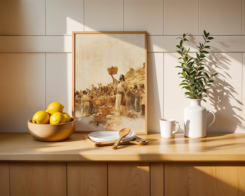May include: A framed print depicting a biblical scene of a figure holding a basket above a crowd, placed next to a wooden bowl of yellow lemons, a stack of white plates with a wooden spoon, a white mug, and a white pitcher with green leaves.