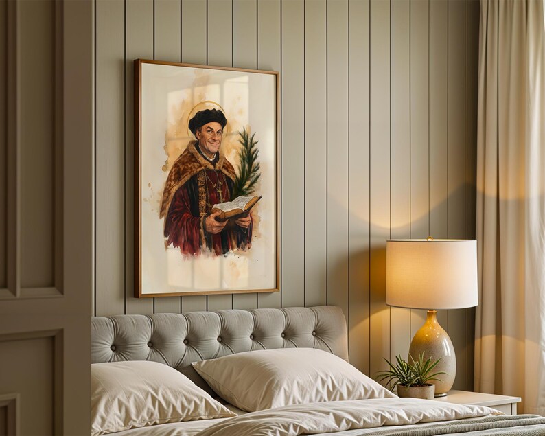 May include: A framed wall art print depicting a historical figure wearing a dark cap and a fur-trimmed robe, holding an open book and a green palm frond. The figure has a golden halo behind their head, rendered in a watercolor style with warm tones.