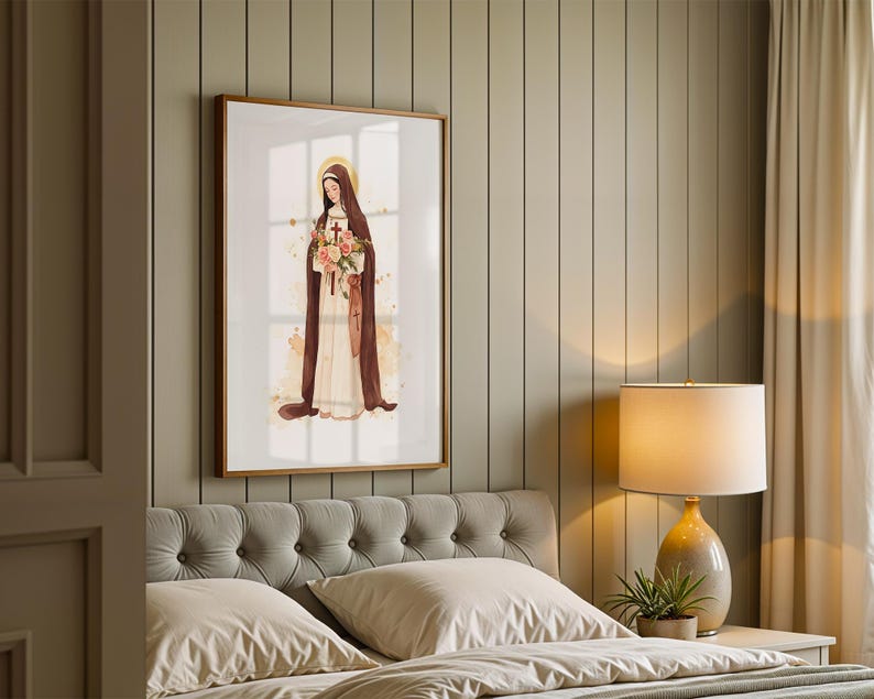 May include: A framed wall art print featuring a watercolor illustration of a figure in a long cream-colored habit and a dark brown cloak, holding a bouquet of pink and orange flowers with a small wooden cross, set against a white background.