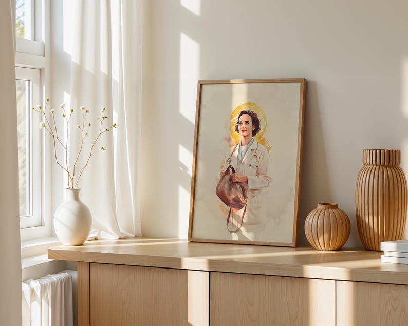May include: A framed vertical art print featuring a watercolor-style illustration of a person in a white medical coat with a stethoscope around their neck, holding a brown bag, with a yellow circular halo effect behind their head.