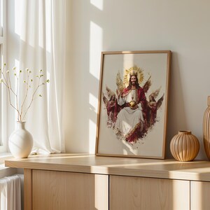 May include: A framed vertical wall art print featuring a central figure with a golden crown and halo, wearing a white robe and red cloak, holding a golden orb, flanked by two winged figures, all rendered in a painterly style with soft edges.