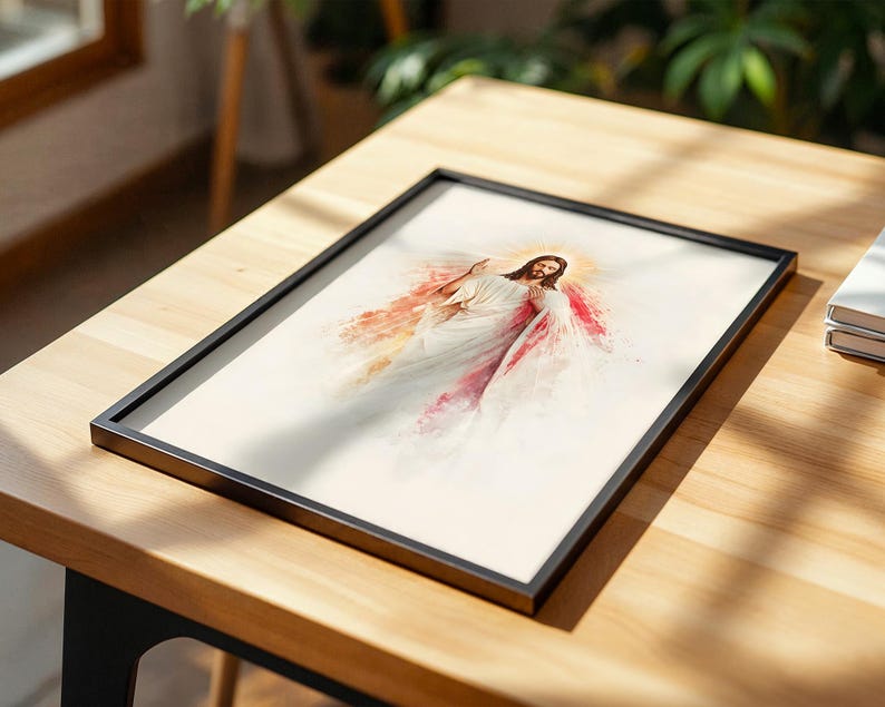 May include: A framed print featuring a watercolor-style illustration of a figure with long brown hair and a beard, wearing white robes. The figure has one hand raised and the other near the chest, surrounded by soft red and gold light.