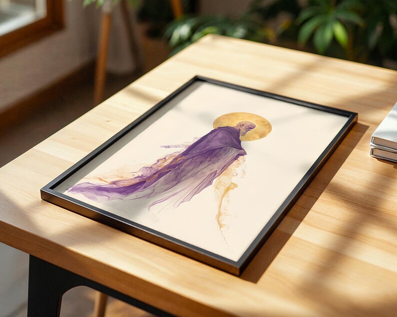 May include: A framed print featuring an abstract watercolour illustration of a figure in a flowing purple robe with a golden circular halo behind the head, set against a cream-coloured background within a thin black rectangular frame.