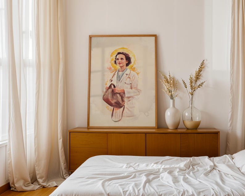May include: A framed vertical art print featuring a watercolor-style illustration of a medical professional in a white coat with a stethoscope around their neck, holding a brown bag, set against a soft yellow halo-like background.
