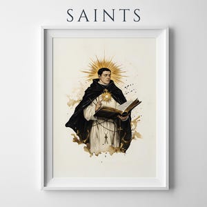 May include: A framed print titled SAINTS featuring an illustration of a figure in a black and white habit holding an open book. A golden sunburst halo radiates from behind the head and a smaller sun emblem rests on the chest, set against a cream background.