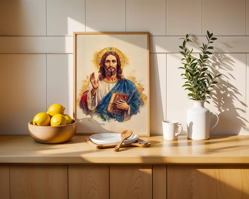 May include: A framed wall art print featuring a watercolor-style illustration of a figure with long brown hair and a beard, wearing a white robe and blue cloak, holding a book with one hand raised in a gesture, set against a light background.