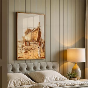 May include: A framed wall art print depicting a large wooden ship under construction in a desert landscape with figures in robes standing nearby. The artwork features warm tan, brown, and beige tones, showcasing detailed craftsmanship of the vessel.