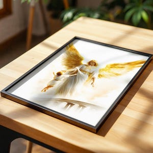 May include: A framed print featuring an illustration of a winged figure in a white robe with large golden wings, carrying a small child in white clothing above a bridge, set against a soft, light-colored background with golden highlights.