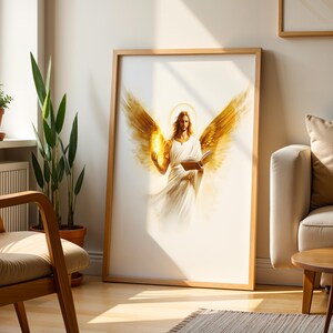 May include: A framed vertical wall art print featuring a central figure with large golden wings, a glowing halo, and long hair, wearing a white robe. The figure holds an open book in one hand and a small flame in the other, set against a white background.