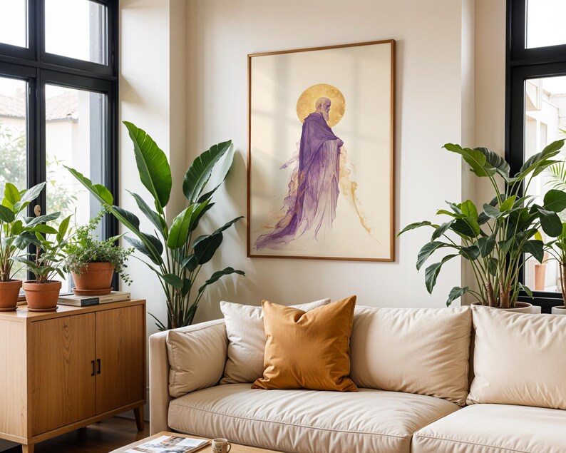 May include: A framed wall art print featuring a side profile of a bearded figure in a flowing purple robe with a golden halo, displayed on a light-coloured wall above a beige sofa with a mustard yellow throw pillow in a bright living room.