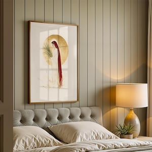 Puede incluir: Una l&aacute;mina de arte enmarcada que muestra una figura con t&uacute;nica blanca y un largo velo rojo, sosteniendo una hoja de palma sobre un gran fondo circular dorado. La obra est&aacute; expuesta en un marco de madera sobre una pared con paneles verticales.