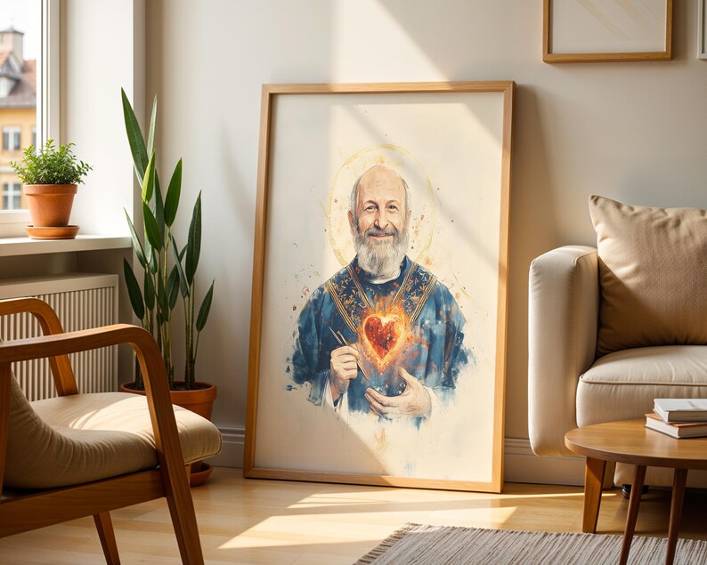May include: A framed wall art print featuring a watercolor-style portrait of a bearded man with a golden halo, wearing a blue vestment and holding a glowing, fiery heart in his hands, set against a light, neutral-toned background.